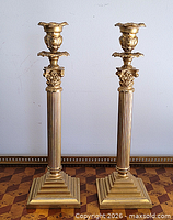 Pair of brass Corinthian candlesticks, no glass