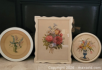 Three framed botanical prints standing side by side