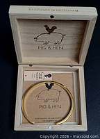Bracelet inside open Pig & Hen wood box