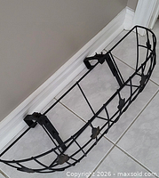 Top angled view of metal window planter showing curved basket shape and mounting brackets