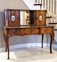 Front view of one Bonheur du jour showing veneer, ormolu mounts, porcelain plaques, brass gallery, cabriole legs