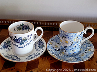 Both Royal Albert cup and saucer sets side by side