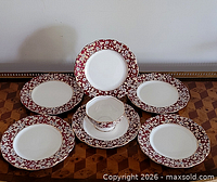 Complete set: six plates arranged with bowl on centre plate