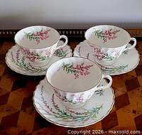 Set of three cups and three saucers displayed