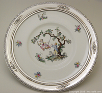 Full view showing entire porcelain plate with sterling silver rim and painted scene