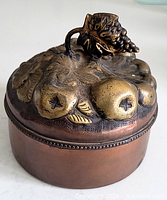 angled view of brass fruit motif lid and box body