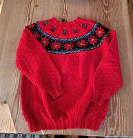 front view of red Dale of Norway wool sweater showing pattern and overall condition