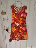 Front view of sleeveless floral dress on hanger