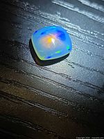 Top view showing overall cushion cabochon shape and play-of-colour.