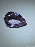 Top view of pear cut amethyst showing color and faceting