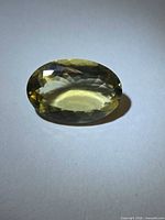 Top view of oval lemon citrine showing faceting and colour