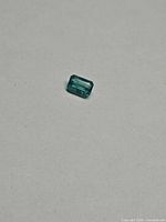 Rectangular emerald stone on neutral background