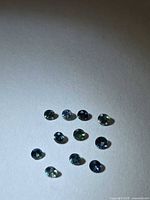 Group of round multicolored sapphires on white background