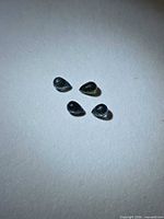 Four briolette sapphires on neutral surface