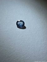 Front view of aqua blue sapphire showing oval cut and transparency