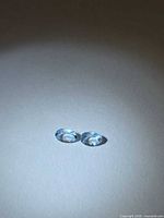 Front view of both oval aquamarines showing color and cut