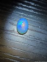 Front view showing oval shape and play-of-color