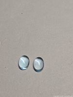 Front view of both oval cabochons showing color and clarity