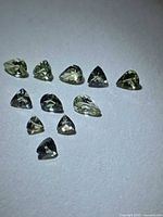 Group view of all 11 lemon-lime Tanzanite stones