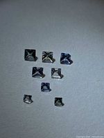 Top-down view of all eight square princess-cut tanzanites