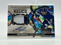 Front of card showing patch, autograph, player image, serial number, set branding