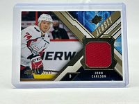 Front of card showing player image, red jersey swatch, serial number and Spectrum design