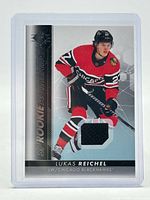 Front of card showing Lukas Reichel image and jersey patch