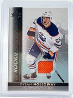 Front of card showing Dylan Holloway image, set branding and orange jersey patch