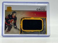 Front of card showing player image, jersey swatch, serial number