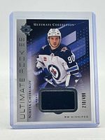 Front of card showing player image, jersey swatch, serial number