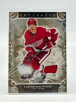 Front view of Lucas Raymond Artifacts patch card showing player image, patch window and serial number