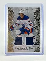 Front of card showing player image, two jersey swatches