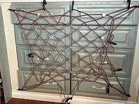 Full view of bungee cargo net stretched against cabinet