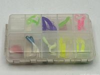 closed tackle box showing assorted lures through lid