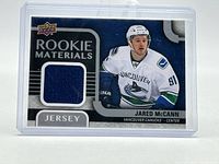 Front of card showing player image, Rookie Materials text and blue jersey swatch