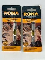 Front view showing two sealed Rona line levels on cards