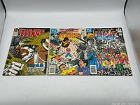 Group shot of all three comic books laid flat