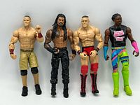 All four wrestling figures standing in a row