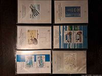 Six Finnish annual stamp pack booklets in plastic sleeves displayed