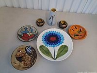 All seven ceramic pieces displayed