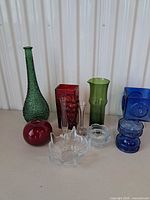 Full group of assorted art glass pieces displayed on table