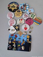 Group shot of all large buttons and board of lapel pins