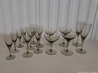 Full group of 16 smoke-grey stemmed glasses