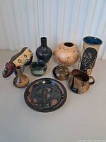 All eight pottery items grouped on table