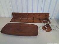 Oblong teak platter, slotted rack, chrome ring stand overview