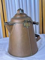Full view of copper kettle showing overall shape and handle