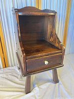 Front view of Ethan Allen pine nightstand showing open cabinet and drawer