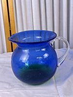 Full view of glass pitcher showing color gradient and shape