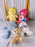 Group shot of five plush toys showing variety and overall condition