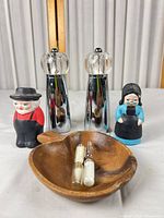 All items in lot: pair grinders, two figurines, wooden bowl, three sand timers